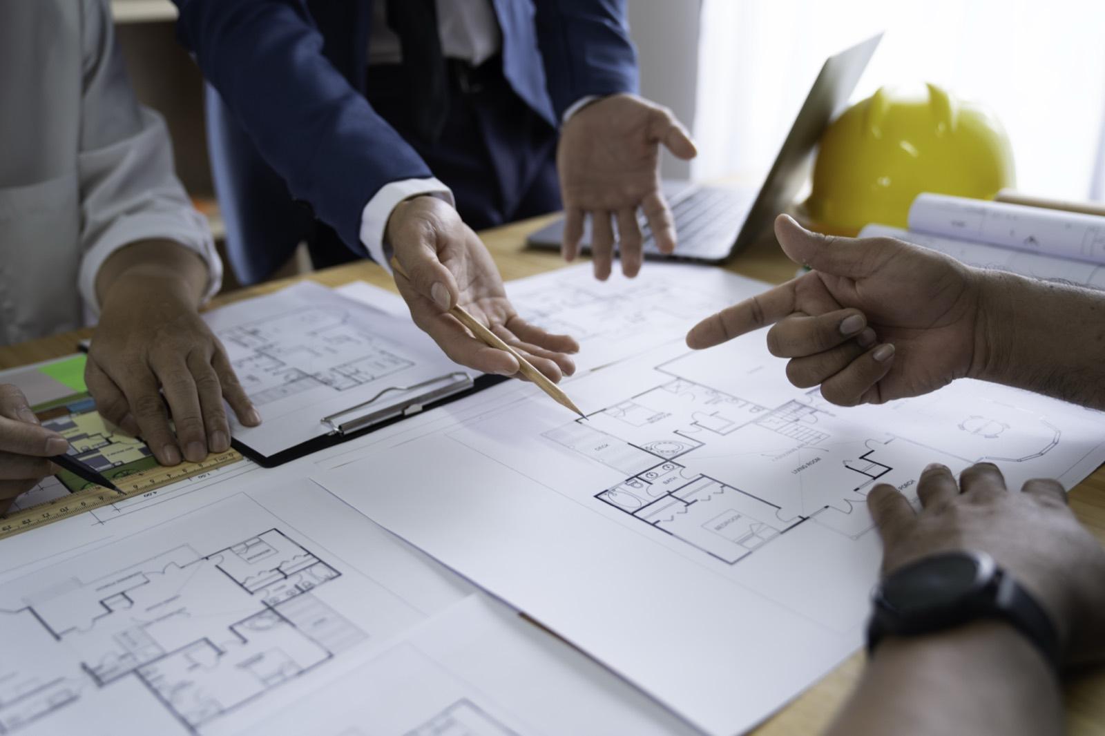 Equipo revisando los planos de una vivienda sobre la mesa